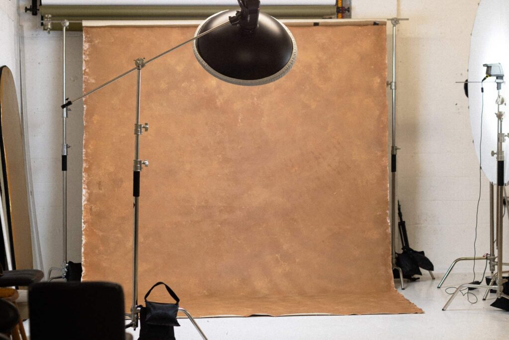 Hand-painted brown photography backdrop with studio lights